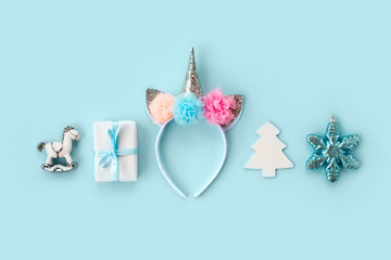 Set of various white and silver Christmas details: gifts and toys on light blue background. Top view, flat lay.