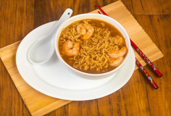 Ramen Noodles with Shrimp on Rustic BG with Chinese Soup Spoon and Red Chopsticks