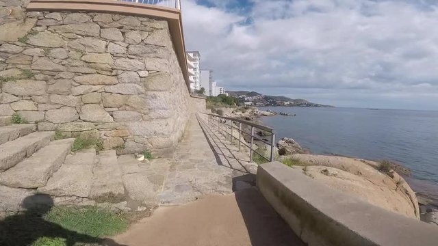 Road path trek along the Mediterranean Sea Costa Brava in Spain Catalonia. View from an action camera with a mountain bike handel bar