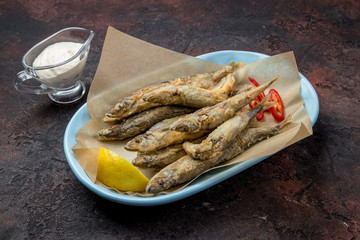 fried surmullet on dark concrete rustic table
