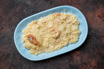 risotto with seafood on dark concrete rustic table