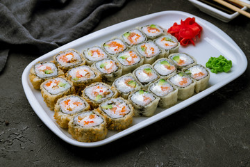 set of tempura rolls on black concrete table