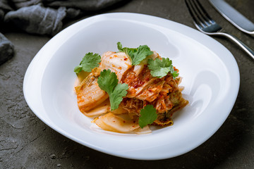 kimchi salad with cabbage on black concrete table