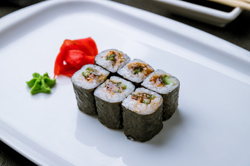 roll with eel on black concrete table