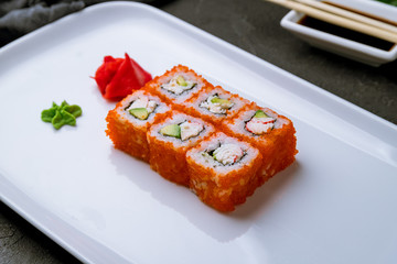 California roll with crab on black concrete table