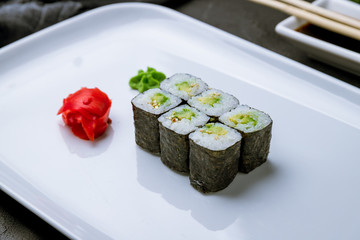 roll avocado Maki on black concrete table