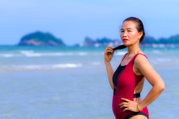 Woman body large with bikini  crimson on beach