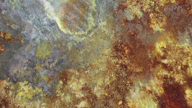 Overhead drone shot flying over steaming sulfuric crater of Dallol hydrothermal field, bizarre natural scenery and geology in Ethiopia Africa