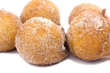 Traditional Brazilian mini fried cakes called bolinho de chuva isolated in white background close
