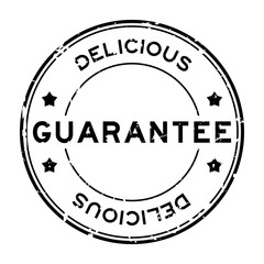 Grunge black guarantee delicious word round rubber seal stamp on white background