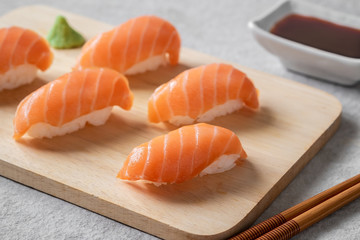 Salmon nigiri sushi on wooden plate, Japanese food