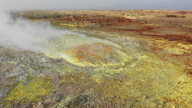 Ascending drone shot of spectacular sulfuric volcanic Dallol crater in the Danakil Depression, surreal natural scenery in remote location in Ethiopia, Africa