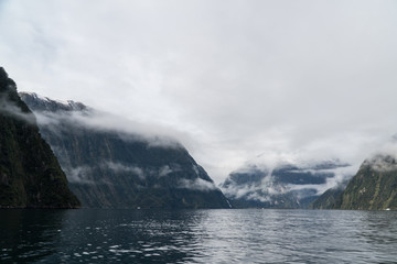 Fototapeta na wymiar low clouds in Milford Sound, New Zealand