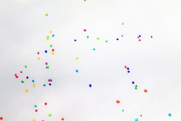 Balloons against the sky with clouds.