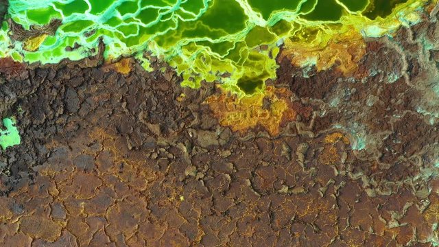 Flying over abstract patterns of Dallol volcanic crater, surreal natural landscape in Ethiopia