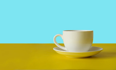 Cup of coffee on colorful background