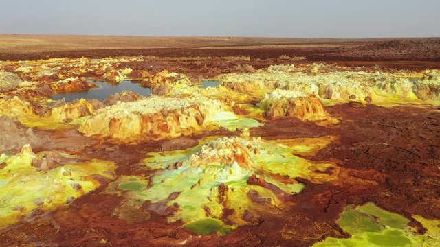 Flying over bubbling hydrothermal fields with sulfur, iron and other mineral deposits, amazing natural scenery in Ethiopia, Africa