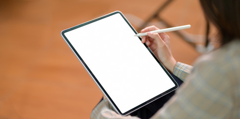 Young businesswoman writing on blank screen tablet