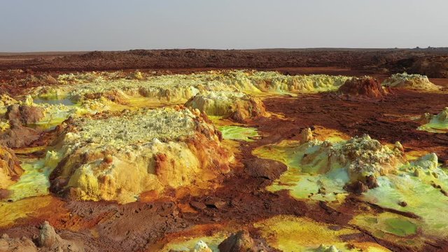Drone flight over pools of acid sulfuric minerals at Dallol volcanic crater in the Danakil depression, spectacular natural landscape in Ethiopia Africa