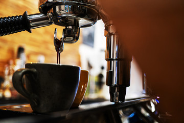 coffee maker is brewing the espresso from the machine