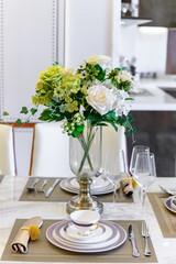 beautiful table setting with kitchen at background