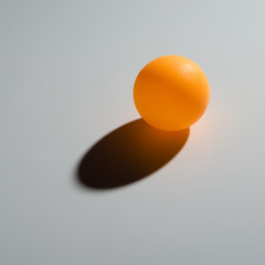 yellow pingpong ball on grey background