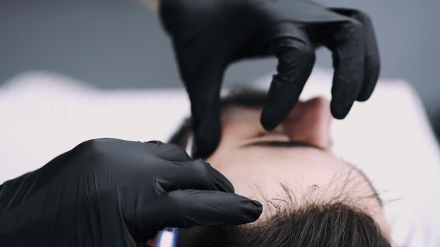 professional businessman getting his beard froomed and trimmed by a barber