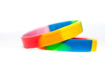 A pair of pride rainbow wristbands