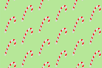 Seamless watercolor pattern with sweet candy cane sticks. New year festive background. Template for fabric or wrapping paper print. Hand drawn illustration. Christmas decoration food objects.