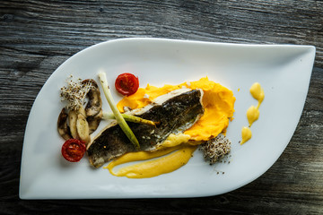 top view on puree originally decorated with fried fish and vegetables