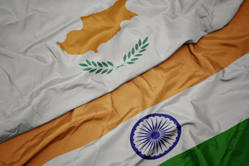 waving colorful flag of india and national flag of cyprus.