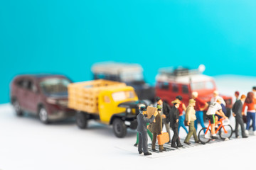 Miniature toys of a man reading newspaper, oblivious of his surrounding while crossing a street, reading habit concept.