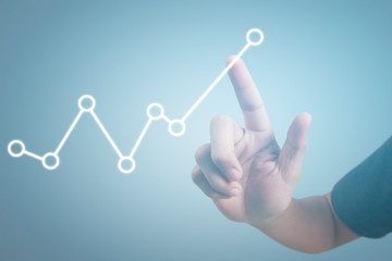 Hand touching graphs of financial indicator and accounting market economy analysis chart