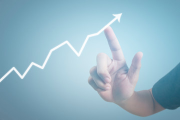 Hand touching graphs of financial indicator and accounting market economy analysis chart