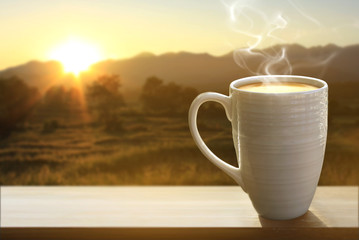 Coffee cup and coffee beans on wood table..