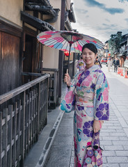 Japanese Woman in Kimono walking on a street of Gion in Kyoto Japan.