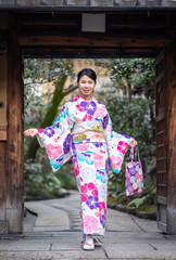 Japanese Women in Floral Printed Long Kimono in Gion House is an old wooden, traditional style at Gion Shijo Kyoto Japan.
