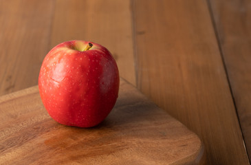 Fresh apple placed on a wooden table.
