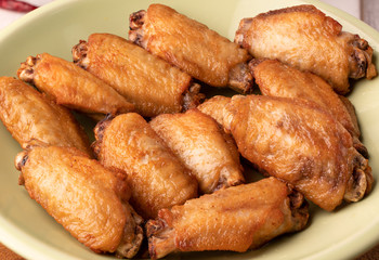 Crispy Baked Chicken Wings on white table.