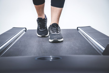 Women wearing exercise walking sneakers on the electric treadmill in fitness.