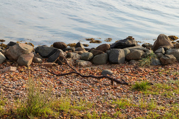 Waves coming in to a stone beach on the island of Ven in southern Sweden during a summer sunrise. 
