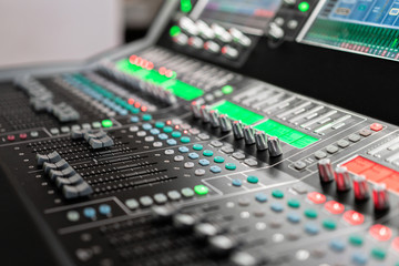 Fototapeta na wymiar od adjusters and red buttons of a mixing console. It is used for audio signals modifications to achieve the desired output. Applied in recording studios, broadcasting, television.