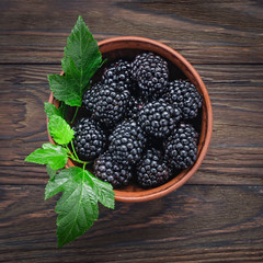 Close-up blackberry in a  wooden bowl. View from above