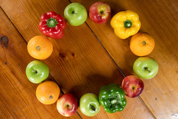 circle fruit and vegetable with a brown wooden background