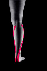 Medical taping for calf pain relief showed on young model.