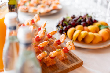 Delicious shrimp and sliced tomatoes. Tasty buffet table. Catering concept