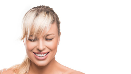 Happy young beautiful woman with closed eys laughing over white background.