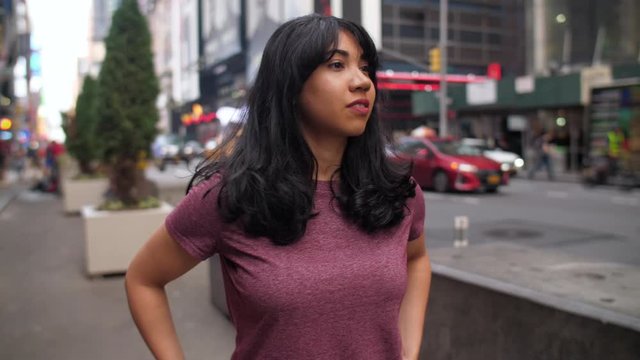 A young Latina woman walks in midtown Manhattan