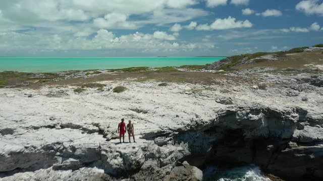 Aerial Drone Video of people adminiring the views of the tropical caribbean sea next to a cliff