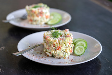 Healthy homemade russian traditional salad olivier ready to eat, close up